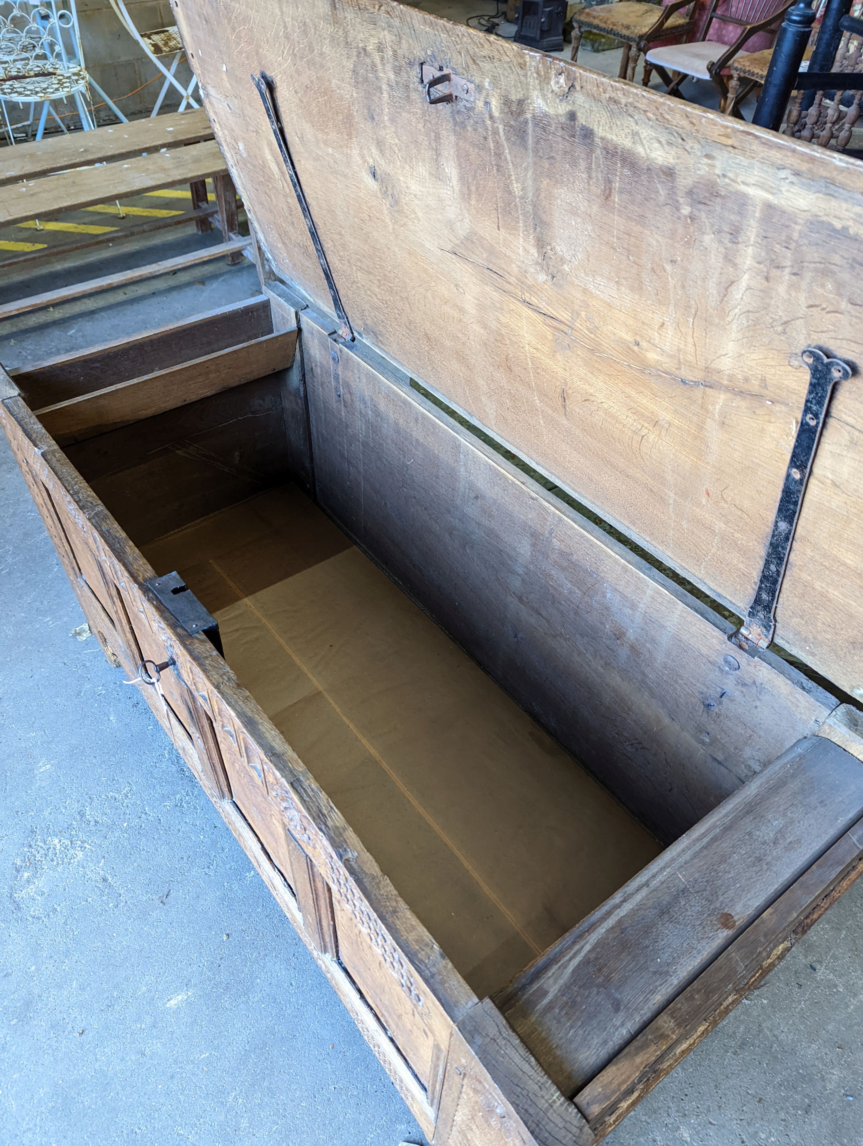 A large 17th century oak panelled coffer, length 147cm, depth 58cm, height 74cm